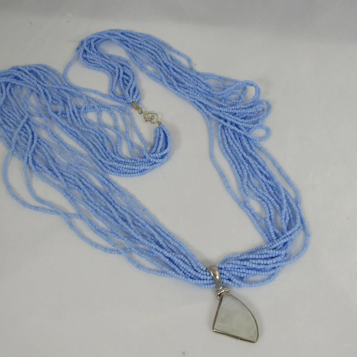 Rainbow Moonstone Pendant on  Blue Multi-strand Necklace